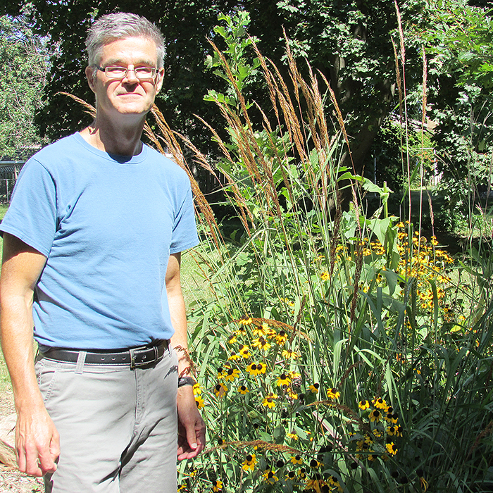 Steve Parr stands in the butterfly garden he planted two years ago to help bring back the population of monarch butterflies that had been decimated by the designation of milkweed plants as noxious weeds.