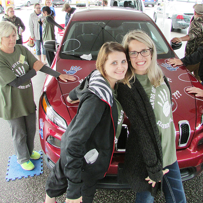 Morgan Dale, left and Jessica Vannieuwenhuyze ham it up and look chipper Saturday morning taking part in Chatham Chrysler’s annual Hands Off! event, despite having already spent 22 hours with their hands glued to the 2016 Jeep Cherokee. Dale eventually defeated all 25 other competitors to win the lease of the Cherokee for a year. The event raised more than $15,000 for local charities.