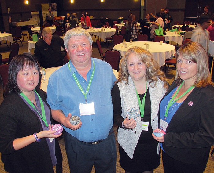 Carol Todd, Mike Neuts, Dr. Leena Augimeri and Leah Parsons hold memory stones painted by Todd to commemorate her visit to Chatham to participate in a children’s mental health summit at the John D. Bradley Centre.