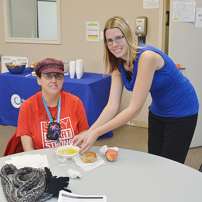 Beth Kominek, a Health Promoter with Chatham-Kent Community Health Centres, serves a bowl of soup to Jana Hayton-Agadzi during the Soup Special for Community Health and Wellbeing Week. 