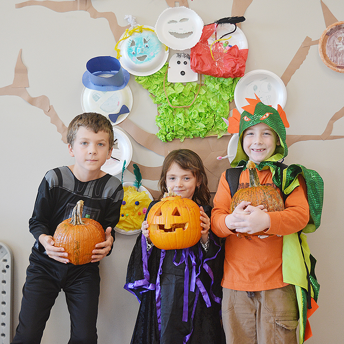 From left, Eric Whitehouse, 9, Rita Barker, 5, and Gino De Santis, 6, hold up carved pumpkins during the Pumpkin Palooza PA day held at the Chatham-Kent YMCA Friday. The day camp consisted of carving pumpkins, pumpkin seed guessing, fun games and swimming.
