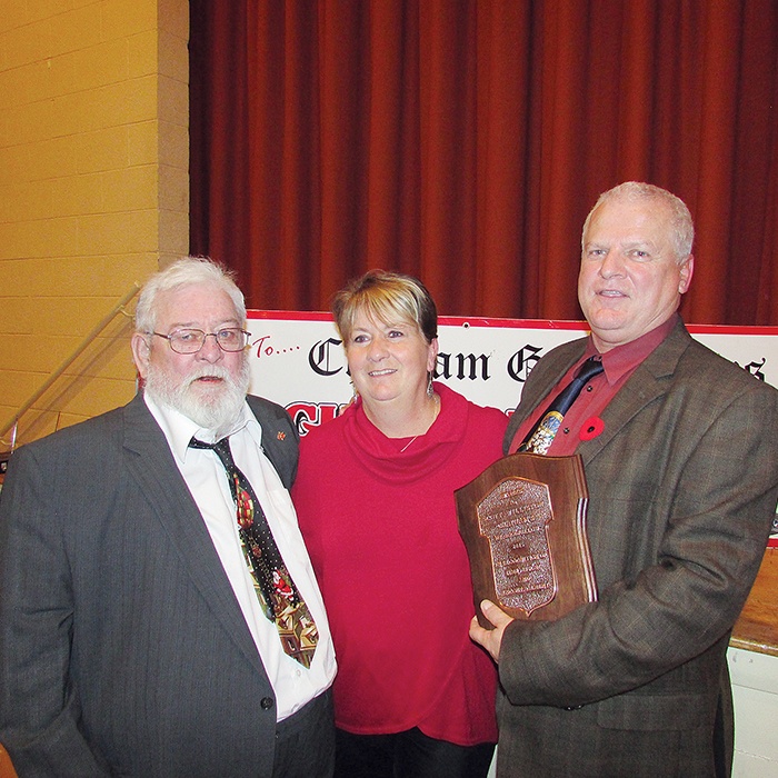 Scott Williston, right, was named Mr. Goodfellow at last night's annual meeting of the group that is launching its No Child Without A Christmas campaign shortly. Here Scott is congratulated by his father Phil and wife Helen.