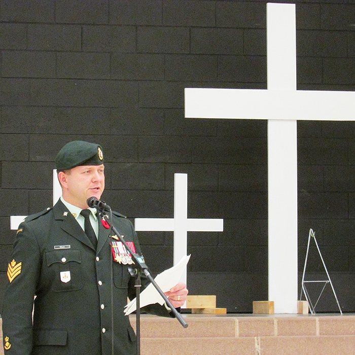 Sgt. Ryan Mills, a Chatham native who served four overseas tours, including two in Afghanistan, speaks to a gathering of students and veterans at Chatham Christian School on Monday.