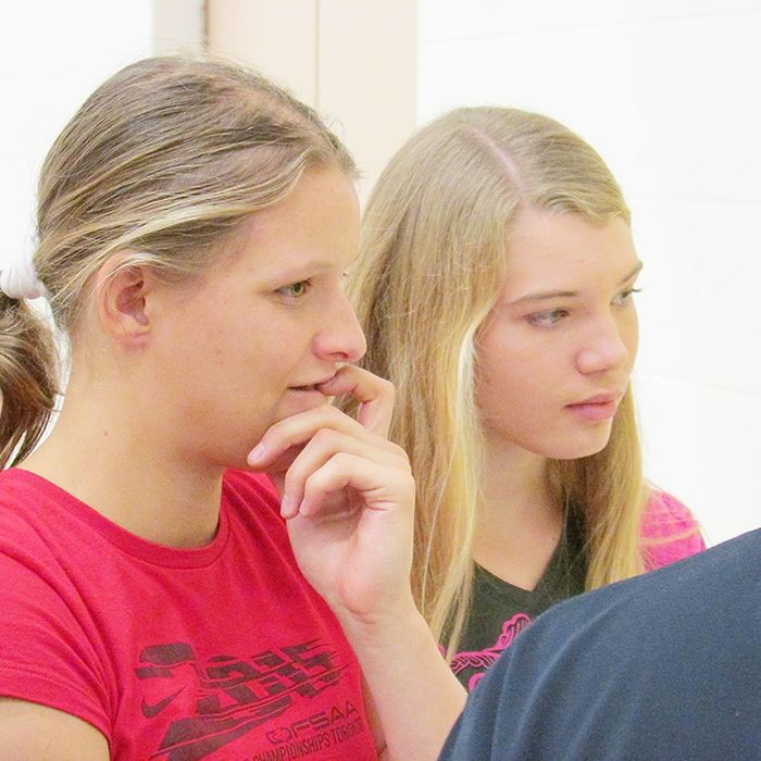 Organizers Amy Koomans, left, and Natasha Lugtiheid ponder the next bracket for the volleyball tournament at the Chatham Christian School Saturday. The Grade 12 students raised $1,263 for the Chatham-Kent Hospice in the tournament that they used as a math project. 
