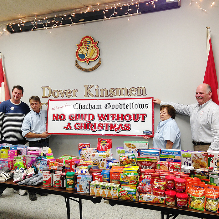 Dover Kinsmen President Larry Cadotte and Secretary, Diane Lucier present their donation of toys and non-perishable food items to Chatham Goodfellow directors Tim Haskell and Tim Mifflin at a dinner Nov. 18 in Grande Pointe.  