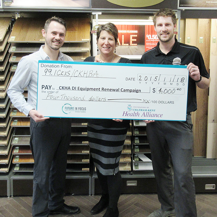 CKXS’s Jay Smith, left, and Kevin Owen, right of the Chatham-Kent Home Builder’s Association, hand over $4,000 to Barbara Noorenberghe of the Foundation of CKHA.