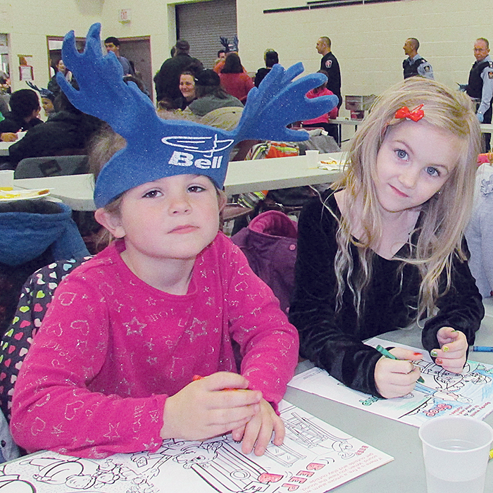 Tina Dyck and Emma Ackworth colour while waiting for Santa to arrive at the Breakfast with Santa event Dec. 5 at the W.I.S.H. Centre in Chatham.