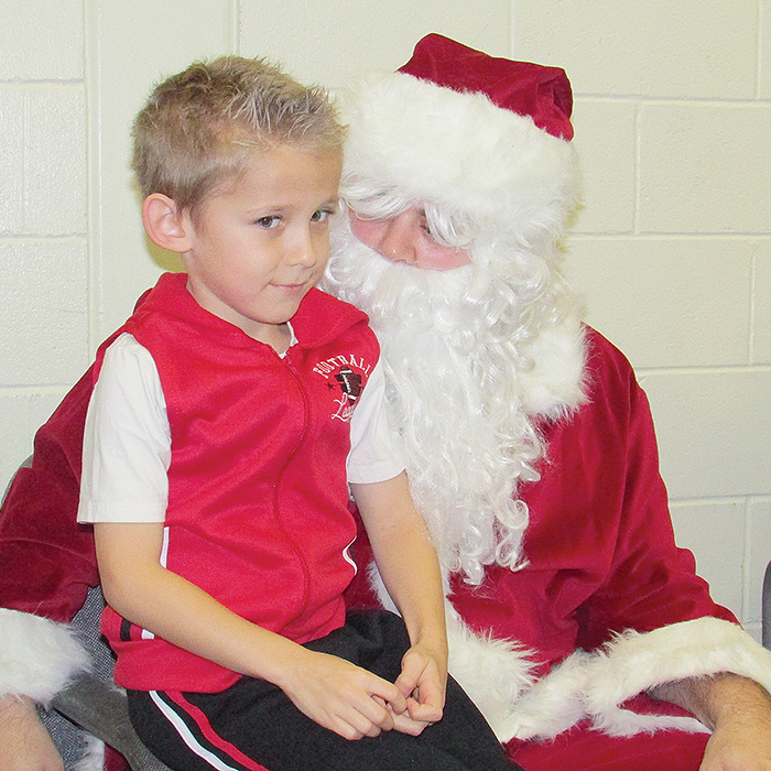 Aiden Lalumiere, 6, listens closely to what Santa has to say Saturday at the annual Breakfast with Santa event at the W.I.S.H. Centre in Chatham.