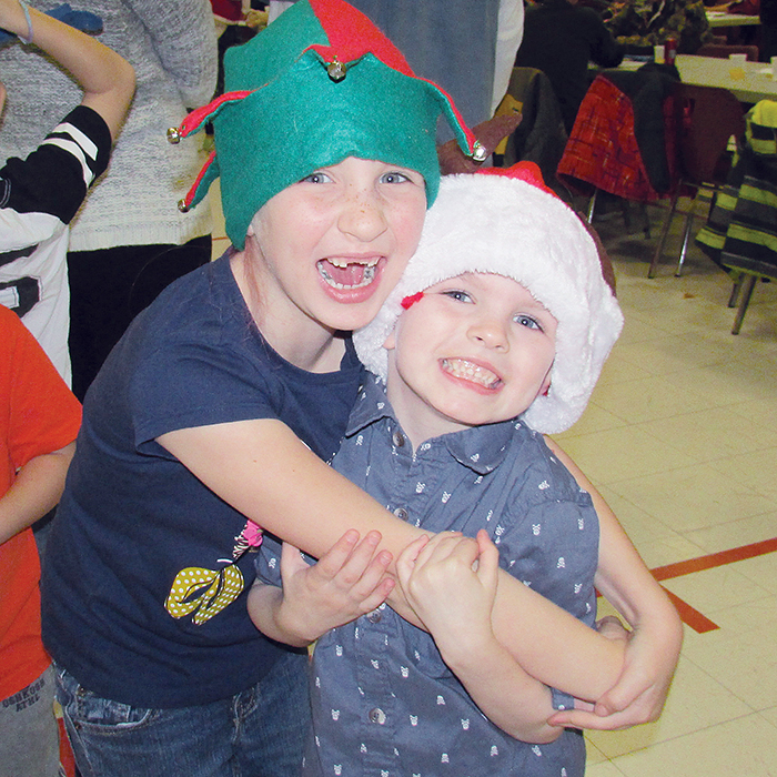 Lora Wyn gives Jacen Crisp a big hug as the pair waits in line for a chance to tell Santa what they want for Christmas.