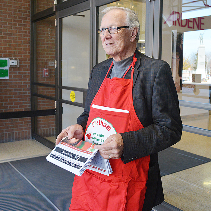 Jim McLachlin spent part of Friday selling the 2015 Chatham Goodfellows paper outside the Downtown Chatham Centre. The organization has volunteers located outside many a local retailer Friday and Saturday, raising money for their annual campaign to ensure “No Child Without a Christmas.” (Zach Moore photo