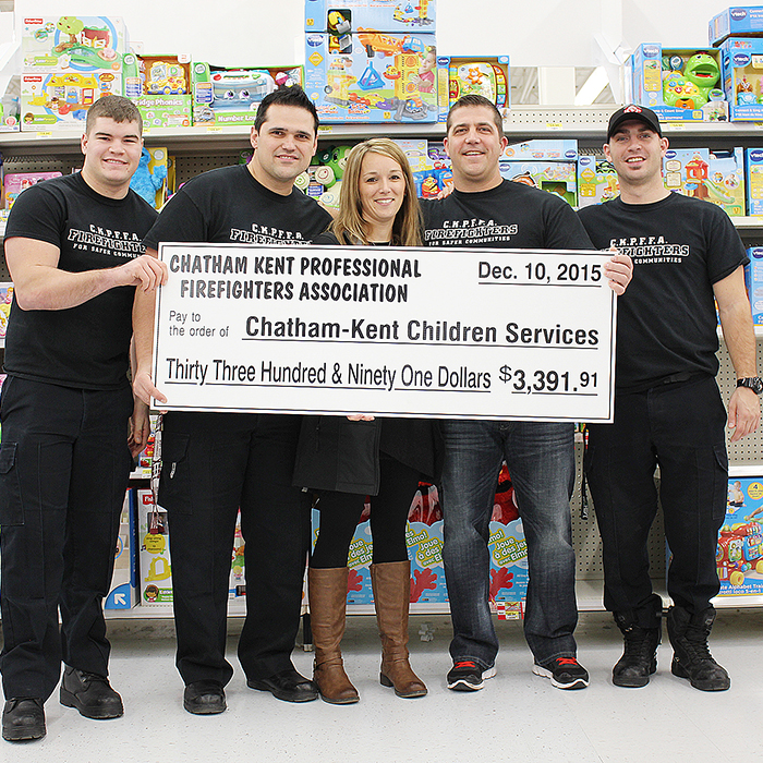Members of the Chatham-Kent Professional Firefighters Association showcase what the organization raised for this year’s Christmas Project.