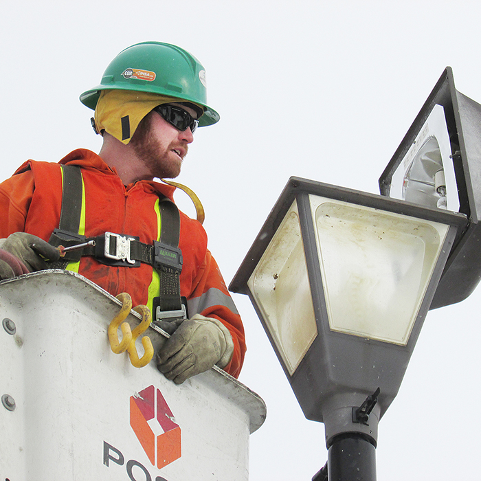 Entegrus lineman Ken Elgie made sure he was bundled up against the elements Monday as he repaired streetlights in Chatham.