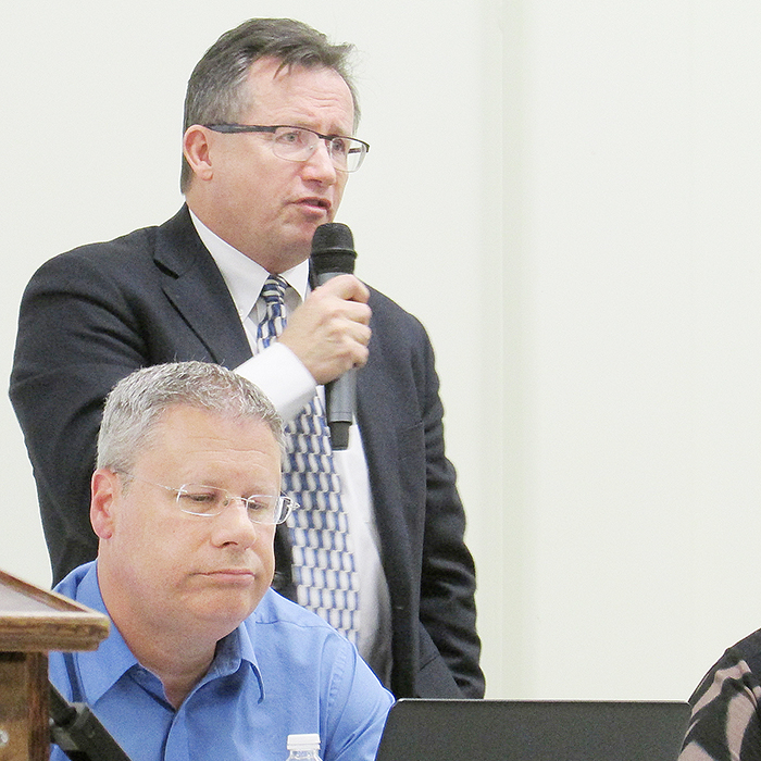 Municipal CAO Don Shropshire answers a question from one of the estimated 100 people who attended a public open house on the proposed 2016 municipal budget Thursday night, while chief financial officer Mike Turner looks on. The Bothwell Arena dominated the night’s discussion.