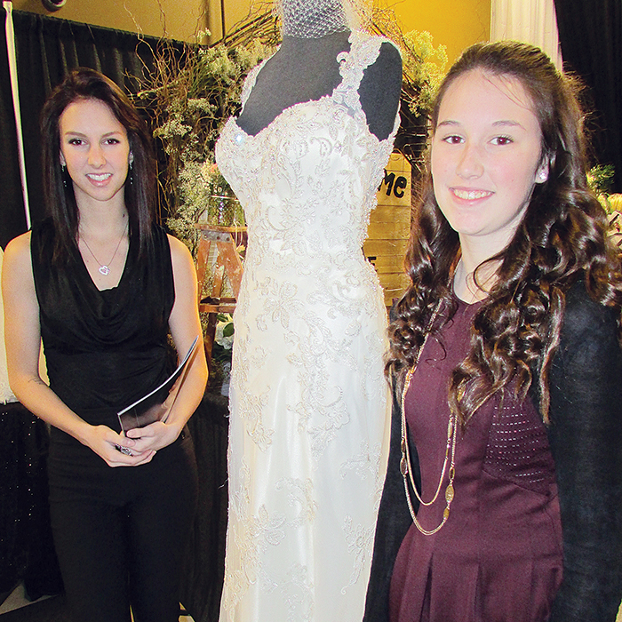 Showcasing gorgeous wedding gowns in the Patricia M. Productions fashion show, Enchantment Bridal and Formal Gowns in Chatham was a headliner at the Wedding Show at the John D. Bradley Centre in Chatham on Saturday. Staff member Samantha Rivard, left, stands with a gown from the Sophia Tolli Collection with help from Melissa Rivard