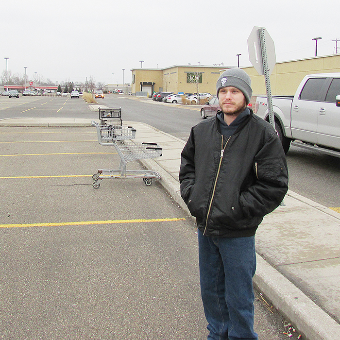 Mark Thomas waits at the Chatham-Kent Transit bus stop at the North Maple Centre on St. Clair Street. Transit users have to wait in the elements for the buses that run every 30 minutes. Former Chatham-Kent councillor Anne Gilbert said the matter should have been resolved years ago.