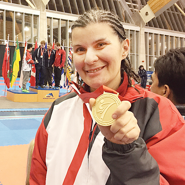 Patricia Wright proudly holds the gold medal she won at the Karate Canada championships in British Columbia, The 39-year-old trains at the Zanshin Dojo Karate Club in Chatham.