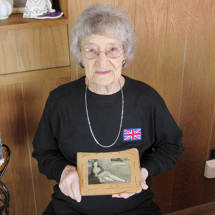 Mildred (Marg) Mills with the photo of her that her husband carried with him through the European campaign in the Second World War.