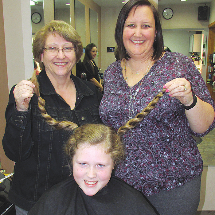 Inspired by a young girl he saw on a TVO Kids segment, Johnathan Core, 10, grew out his hair and had 12 inches cut off on live television to donate to Locks of Love to make wigs for cancer patients. Supporting him while he was live via Skype with TVO, were his Tecumseh Public School Grade 5/6 teacher Wilma Hunninck, left and vice principal Karyn Byatt-Millington.