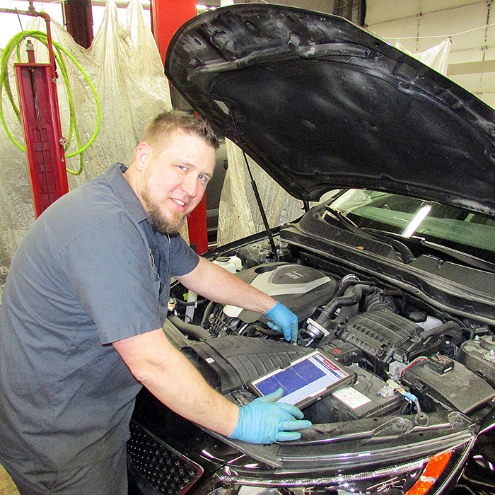 Adam Frenette uses the latest technological devices to diagnose the performance of a Kia at Lally Kia. The Certified Master Service Technician has been named one of the top four in his field in Canada and will be travelling to the United States next month for the North American competition.