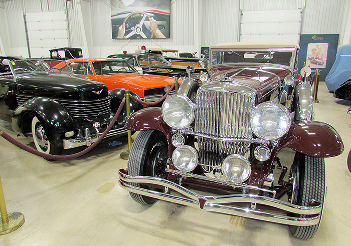 RM/Sotheby’s Classic Car Exhibit had something for everyone before the municipality announced it would be closed. Take for instance this 1930 Dusenberg — with a 1937 Cord coupe, 1969 Charger used in the Dukes of Hazzard , and a 1963 Chrysler Newport Highway Patrol car in the background. 