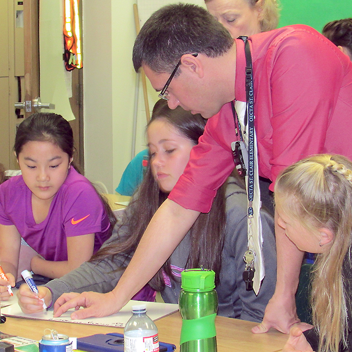 Our Lady of Fatima teacher Dan Rolo goes over a math problem with his class. Rolo and the students are part of TeachOntario initiative, run by the provincial government.