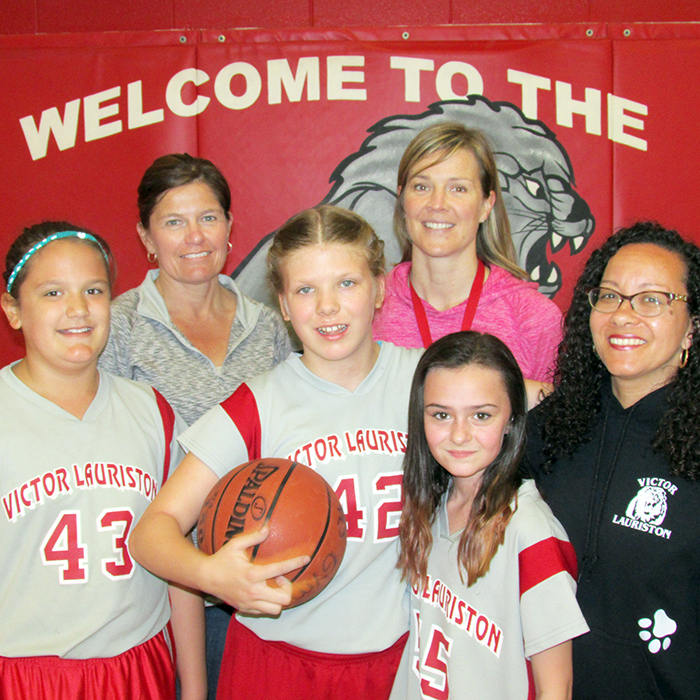 Abby Tedley completed her first year of junior girls’ basketball at Victor Lauriston recently. The autistic Grade 5 student is popular with teammates and the entire student body. Here, front row left to right, are teammates Madison Schatz, Abby and Brooklyn Duquette while in the back row coach Tawnya Carruthers is flanked by educational assistants Carolyn Burton and Tracey Travis.