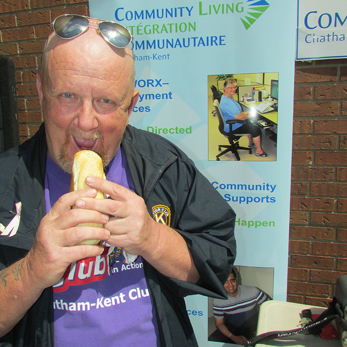 Lenny Moore, a Kinsmen member and Community Living program participant enjoyed a hot dog in front of Chatham-Kent City Hall during the awards presentation during the Community Living Month flag raising.