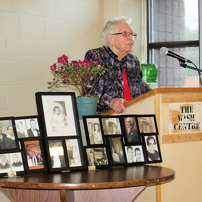 Gwen Robinson speaks at the 17th annual John Brown Festival, surrounded by photos of Mildred Jackson, a longtime member of the Chatham-Kent Black Historical Society to which this year’s event was dedicated.