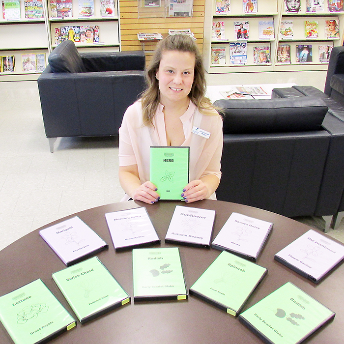 Chelsie Abraham, manager of public services at the Chatham-Kent Public Library, shows off packets of seeds available for lending. More than 50 varieties of fruits, vegetables, herbs and fruits are available to be “loaned.”