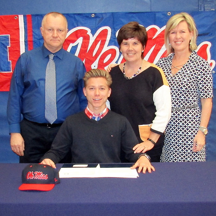 Local distance runner Quinn Cannella will head south this fall, as he accepted an offer from the University of Mississippi May 11. With Cannella, a Chatham-Kent Secondary School student, are, from left, from left to right, Mike McDonald, vice principal; Sharon Lesy of student services; and Julie Anne Costello of resource and special education.