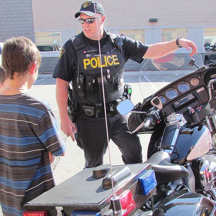 Chatham-Kent OPP motorcycle officer Const. William Van Wyk showcases the police motorcycles during a tour of the Park Ave. OPP detachment Thursday to celebrate Police Week. Over 80 people took part in the tour. Van Wyk, who is also member of the OPP Golden Helmets precision motorcycle team, let the kids on the tour sit on the bike and run the lights.