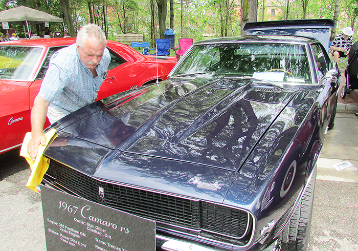 Stan Gillier polishes his new 1967 Chevy Camaro after a little rain sprinkled down over Retrofest on the weekend in Chatham last year.