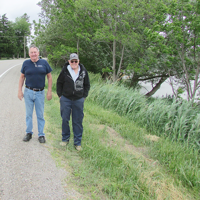 Jack Parry and Marc Roszell, residents along the proposed Round the River Route trail, stand next to one of many spots on Grand River Line that they say will cause problems