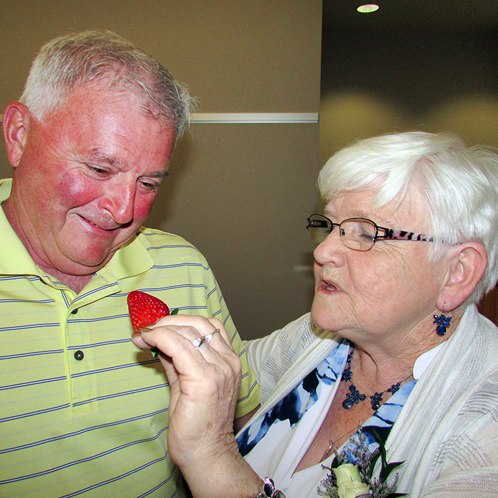 Elaine Lewis feeds Al Davies a strawberry at Lewis’ retirement gathering June 16. She’s retiring after 17 years as co-ordinator of the Student Nutrition Program in Chatham-Kent, and Davies is taking over.