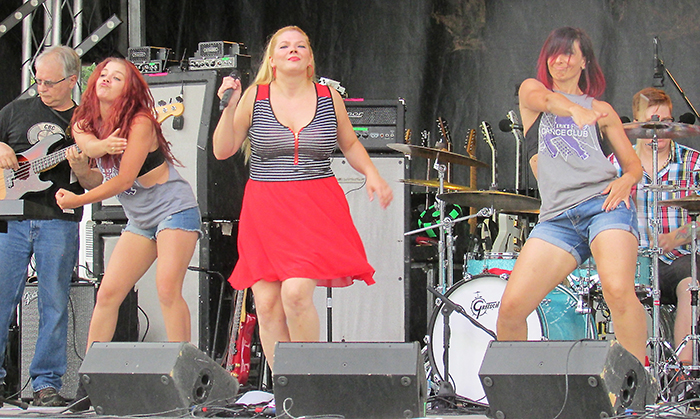 Courtney Wells, lead singer of the Jessika Rabbit Band, lets loose during the third annual Kinstock music festival Saturday in Dresden, accompanied by dancers from Erin’s Dance Club.