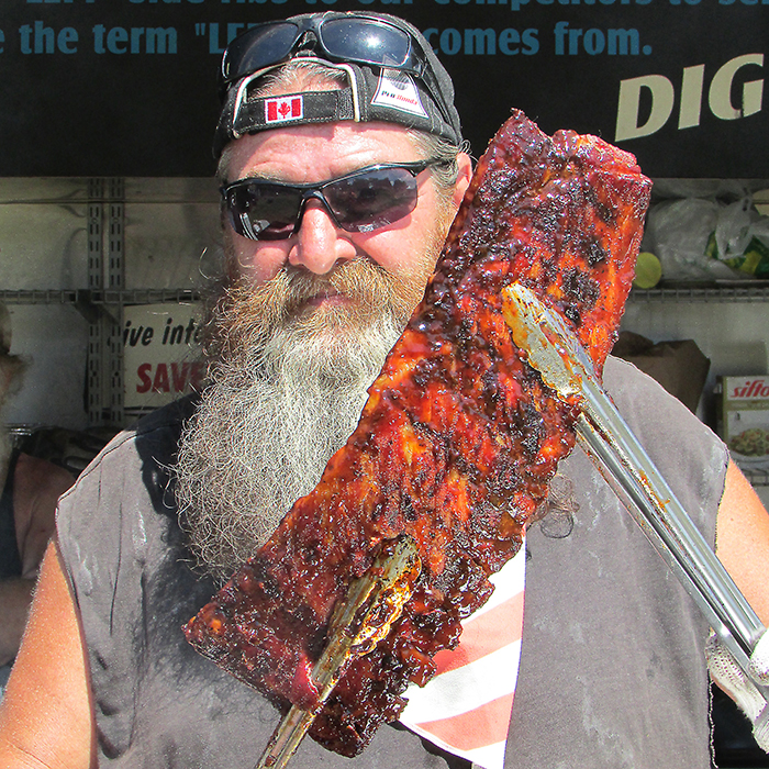 Tex Robert Jr. of the Kentucky Smokehouse showcases a rack of ribs ready for serving at the annual Chatham Rib Fest. The Louisville, Kentucky native said he loves coming to Canada.