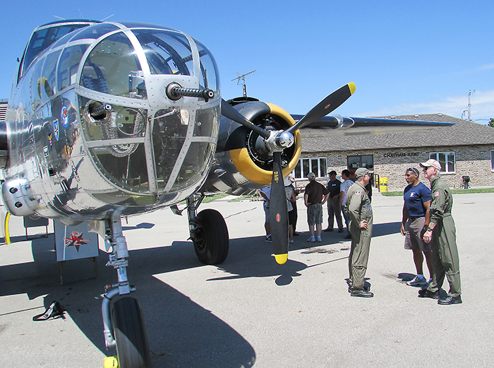 Flight crew and folks who signed up for a flight over Lake Erie chat about The Yankee Warrior, a Second World War vintage B-25 medium bomber that was the focal point of CK Flight Fest Saturday.