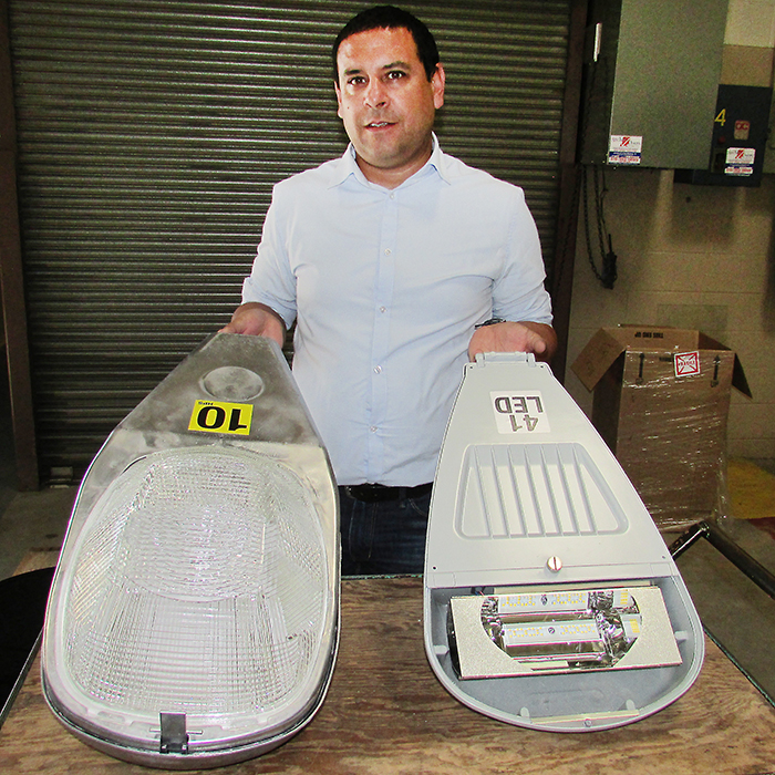 Paul Machado, conservation engineer with Entegrus, shows off a high-pressure sodium streetlight head, left, and its LED counterpart, right. About 6,500 LED lights are replacing the HPS lights along streets in Chatham-Kent, providing more direct light on the street, and conserving energy too.