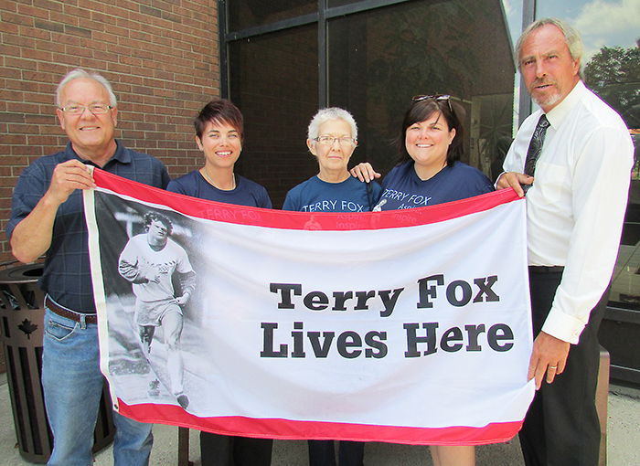 Participating in a flag raising at city hall in Chatham in honour of the upcoming Terry Fox Run is from left, David Reinhart, run organizer Jessica Barton, Denise Reinhart, Christine Beintema and Mayor Randy Hope.