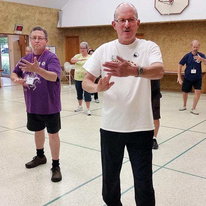 Tai Chi instructor Phil Vallance, right, with Chatham club member Doug Brown, work through the first series of movements in Taoist Tai Chi during a club open house recently.