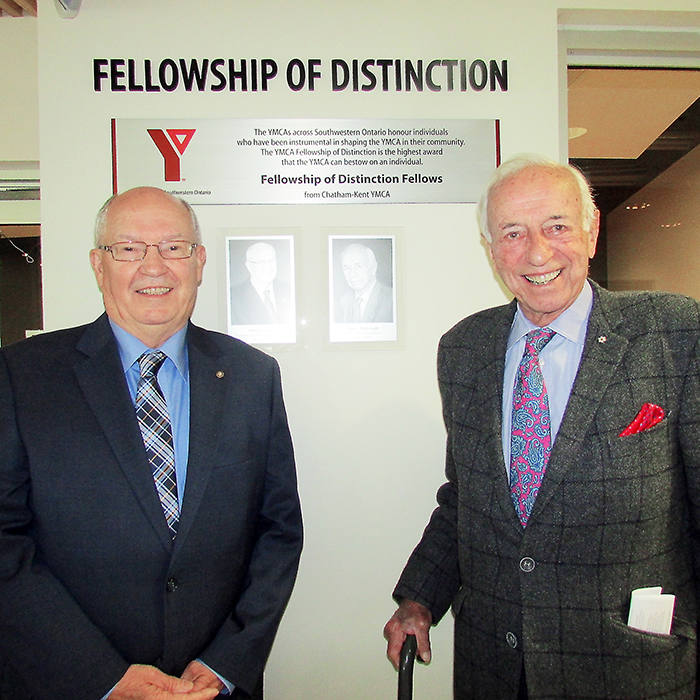 John Lawrence, left, and Darcy McKeough stand with the new display at the Chatham-Kent YMCA which honours their induction into the YMCA Fellowship of Distinction, the highest award given to individuals who have played instrumental roles in bringing the vision of the YMCA from an idea to bricks and mortar.