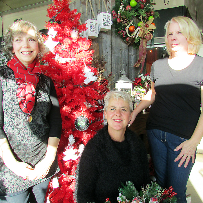 Deb Brooks and Charmaine Reid of Syd Kemsley Florist showcase seasonal decor at the Grand Avenue flower shop with Marianne Johnstone of the Garnet Brackin IODE. The IODE is presenting its annual Christmas House Tour Nov. 19 and 20.