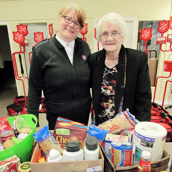 Salvation Army Capt. Stephanie Watkinson takes in all the food items donated with long-time Chatham resident Naomi Dick. For her 85th birthday party, instead of presents, Dick asked for donations for the Salvation Army food bank and Christmas basket programs.