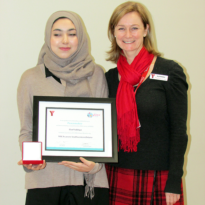 Liz Fletcher, YMCA vice-president, presents the 2016 Peace Medallion to youth category winner Elaaf Siddiqui of Chatham, who is currently attending her first year at McMaster University.