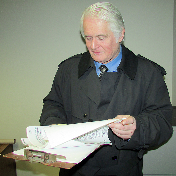 John Cryderman reviews his notes as he prepares to speak to a provincial committee this week in Windsor, offering ideas on how to save money.