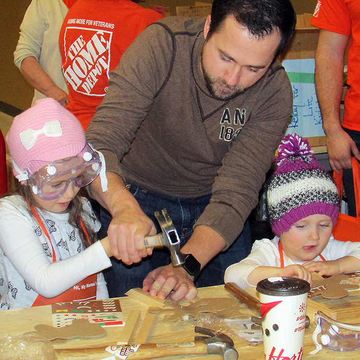 Amelia, 5, and Alexa, 3, try their hand at creating a craft, under the watchful eye of their dad, A.J. Kearney, at the 16th annual Chatham-Kent Toy Show & Sale Sunday at the John D. Bradley Convention Centre.