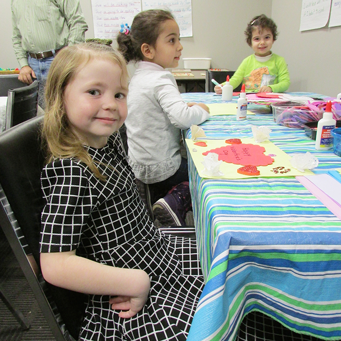 Sara Guenther, 6, foreground, works on a craft at the Adult Language and Learning Centre Jan. 25 during Literacy Day celebrations, with Rand Kamalaldeen, 4, and Sarah Kamalaldeen, 3, with the help of their dad, Ziad.