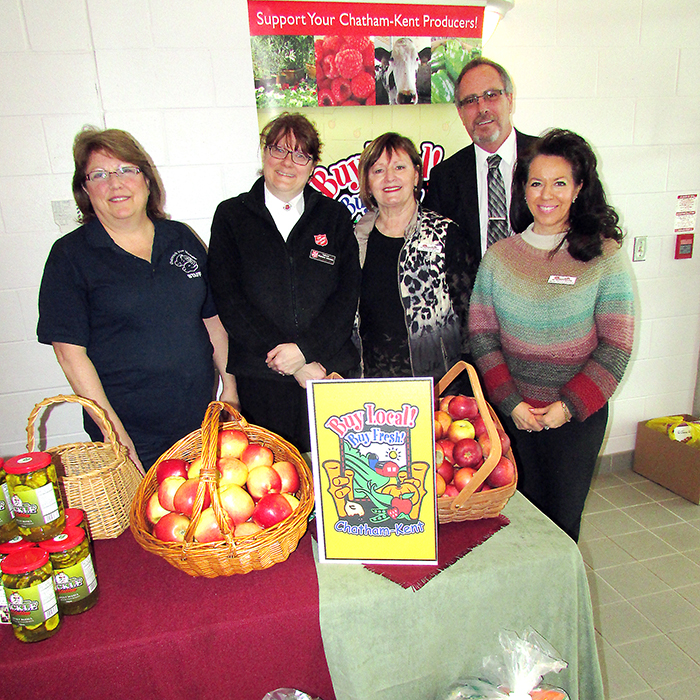 Cindy Parry, Outreach for Hunger, Capt. Stephanie Watkinson, Salvation Army, Alice Uher with the KFA and Uher Performance Feeds, Mary Anne Udvari, KFA, and Mayor Hope stand before a bountiful harvest of local fruits, vegetables and meat donated by area farmers in celebration of Food Freedom Day.