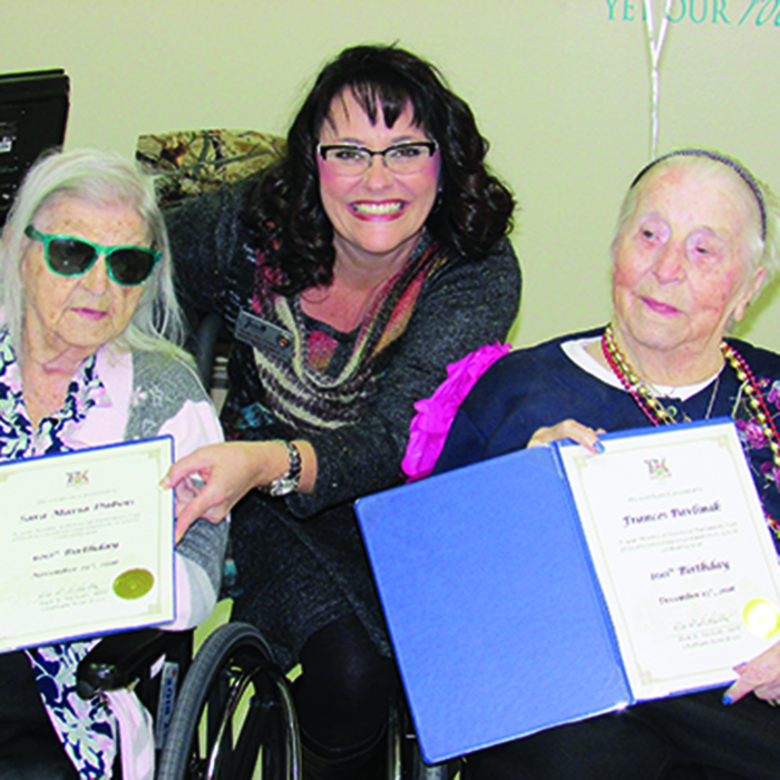 Anne Marie Rumble, centre, shown with two Meadow Park Nursing Home residents, said the province’s long-term care homes need the public’s help to pressure the province to improve funding for seniors’ care.