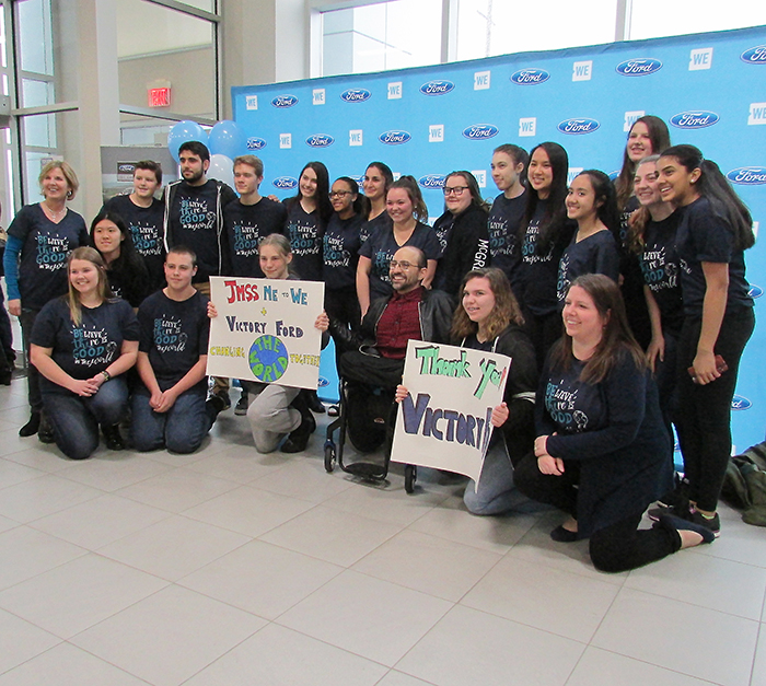 Students of John McGregor Secondary School’s Me to We group are shown with WE ambassador Spencer West, who spoke to local Me to We students at Victory Ford Lincoln March 30. All were there as a celebration of the students’ food-raising efforts last Halloween. The students picked up 25,000 pounds of food for local food banks on that evening.